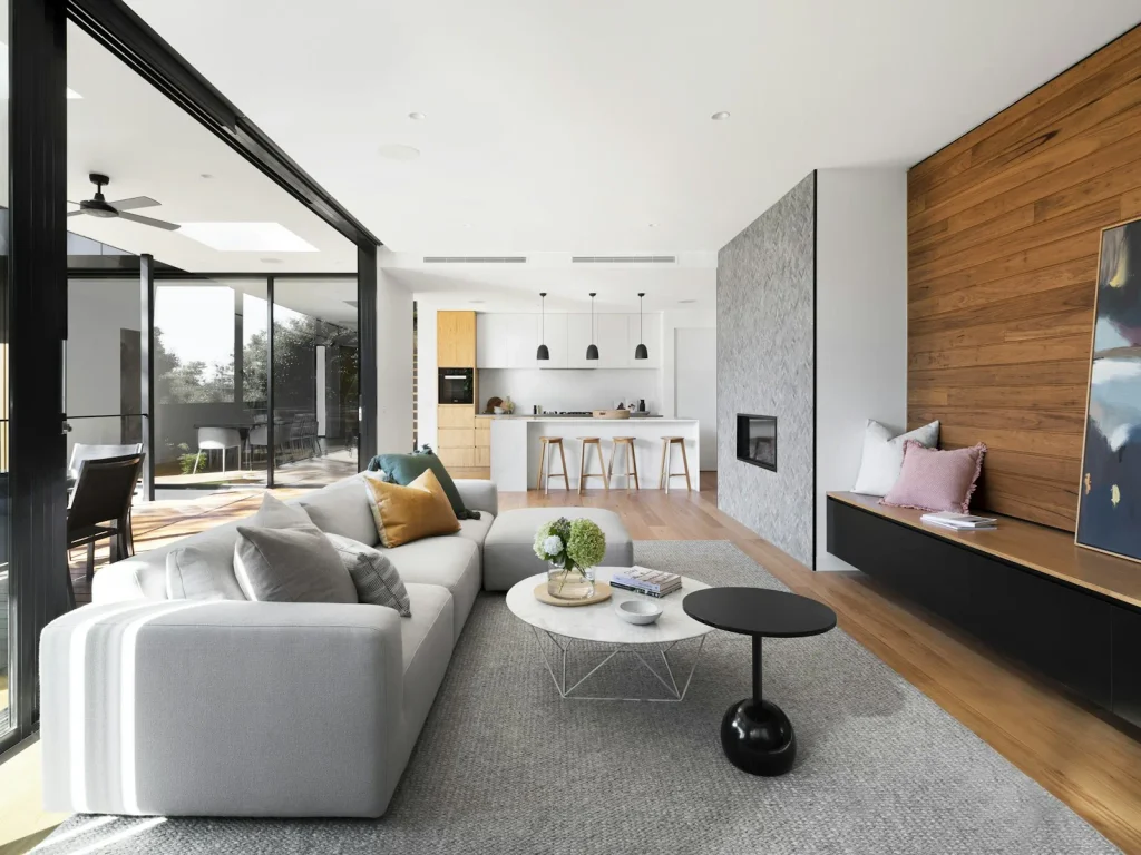 Warm living room interior with wood dining table and soft lighting